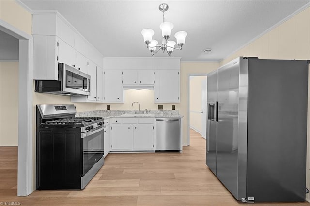 kitchen featuring white cabinetry, crown molding, stainless steel appliances, and decorative light fixtures