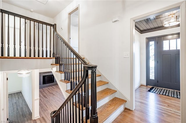 entrance foyer with light hardwood / wood-style floors and crown molding