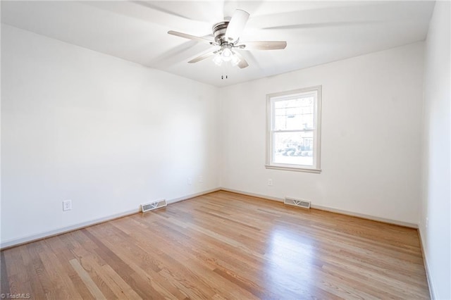 empty room with light hardwood / wood-style floors and ceiling fan