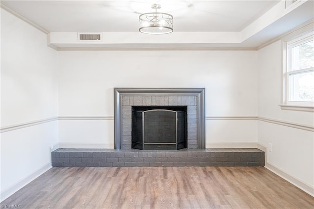 details with a brick fireplace and wood-type flooring