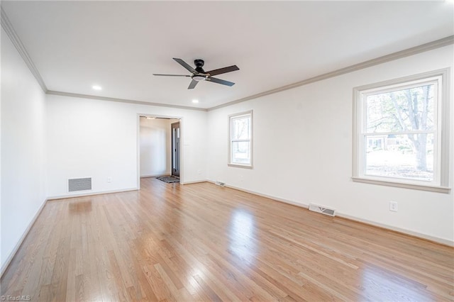 spare room with ceiling fan, light hardwood / wood-style floors, and crown molding