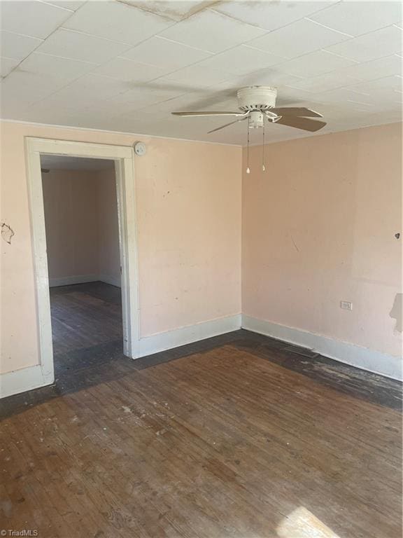 unfurnished room featuring ceiling fan and dark wood-type flooring