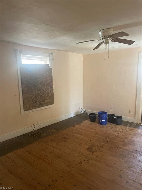 spare room featuring ceiling fan and dark hardwood / wood-style flooring