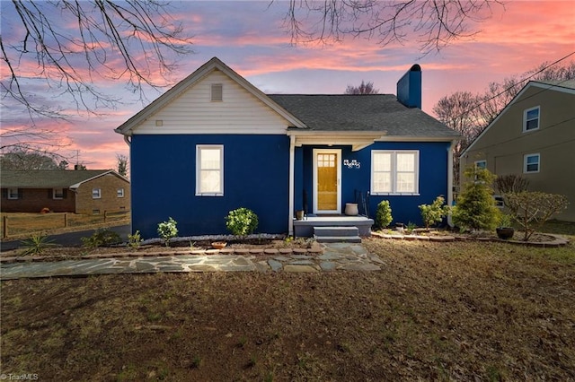 bungalow-style home with a chimney