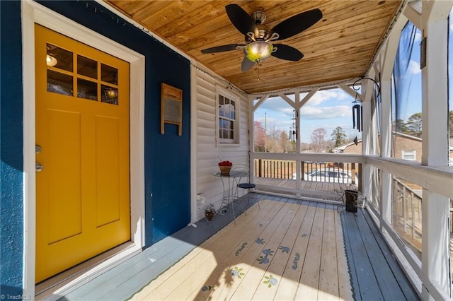 wooden deck featuring a ceiling fan