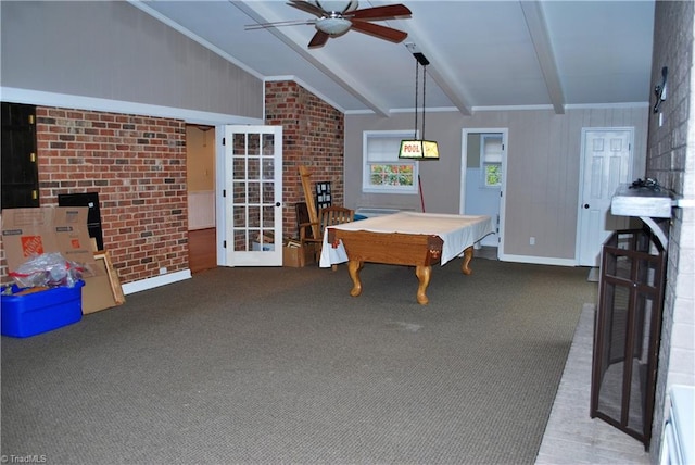 playroom featuring vaulted ceiling with beams, carpet flooring, and brick wall