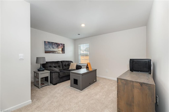 living area featuring visible vents, baseboards, and light carpet