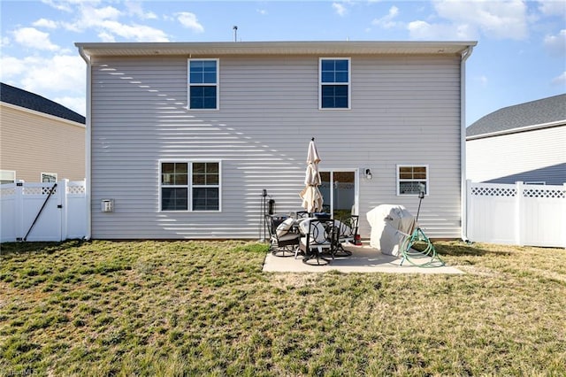 back of property with a gate, a yard, a fenced backyard, and a patio area