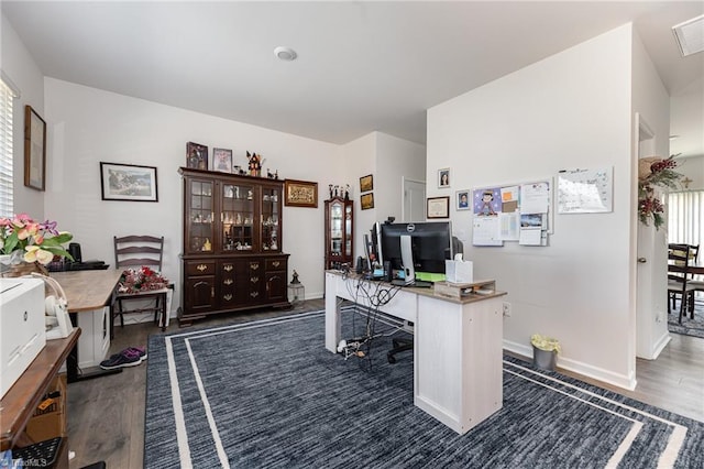 office with visible vents, baseboards, and dark wood-style floors