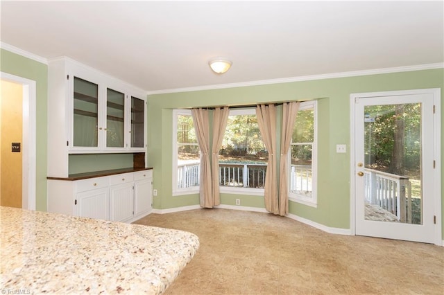 interior space with white cabinetry and ornamental molding