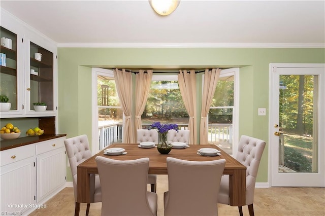 dining room featuring crown molding and light tile patterned flooring