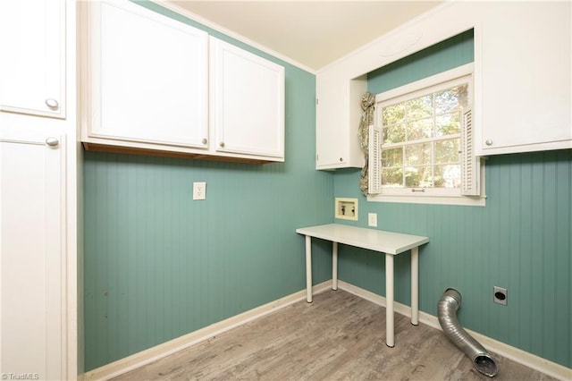 clothes washing area with crown molding, cabinets, hookup for an electric dryer, and light hardwood / wood-style floors