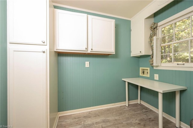 laundry room with washer hookup, ornamental molding, light hardwood / wood-style floors, and cabinets