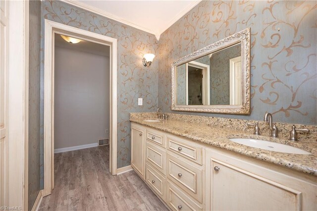 bathroom featuring hardwood / wood-style flooring, vanity, and crown molding