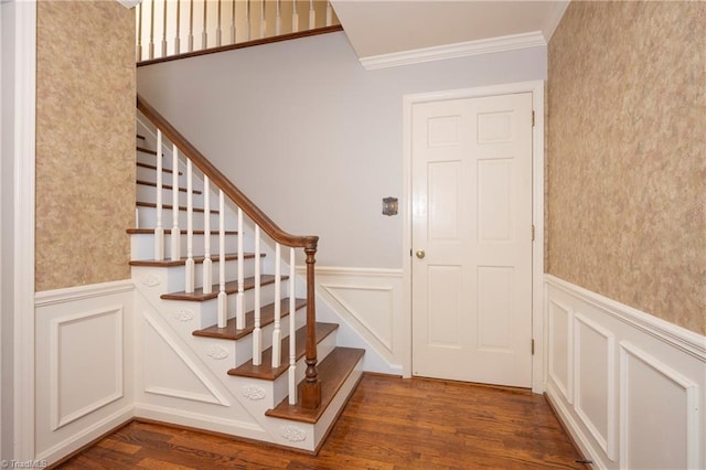 staircase with crown molding and wood-type flooring