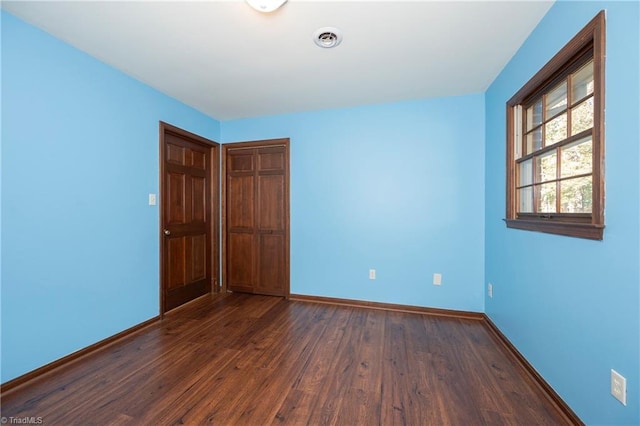 empty room featuring dark hardwood / wood-style flooring