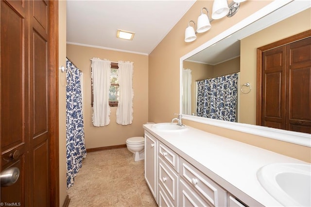 bathroom with vanity, crown molding, and toilet