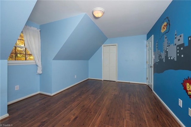 additional living space featuring lofted ceiling and dark wood-type flooring