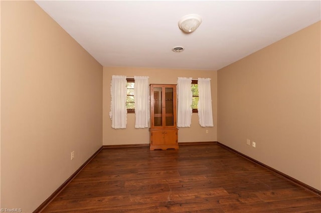 spare room with dark wood-type flooring