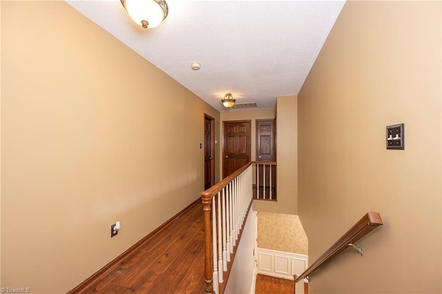 hall with hardwood / wood-style flooring