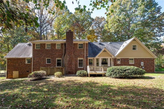 back of house featuring a yard and a deck