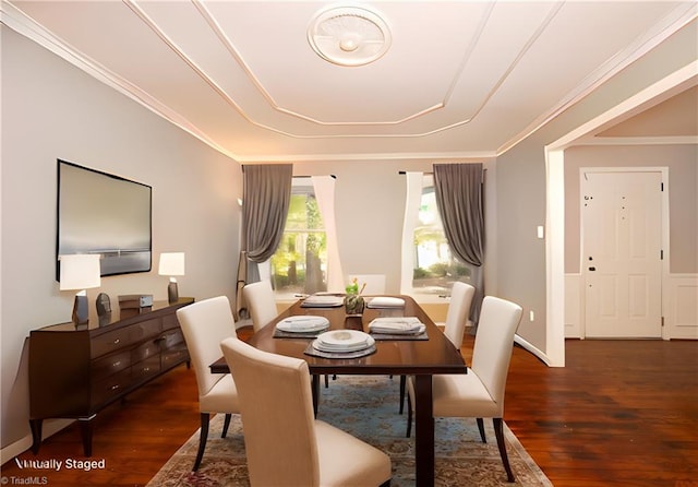 dining area with ornamental molding and dark hardwood / wood-style floors