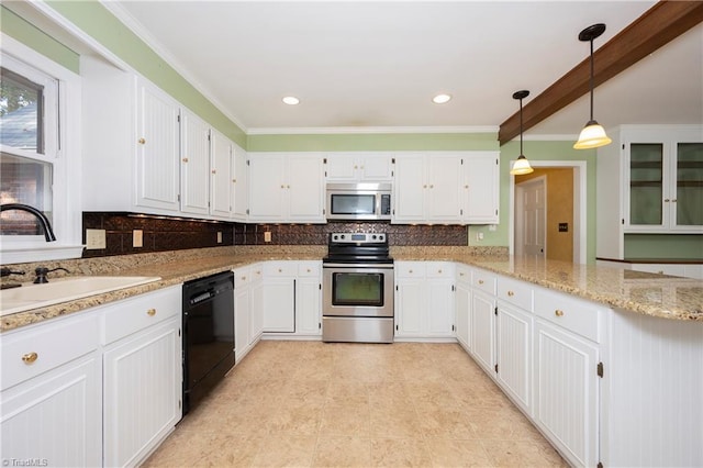 kitchen featuring appliances with stainless steel finishes, white cabinetry, sink, backsplash, and hanging light fixtures