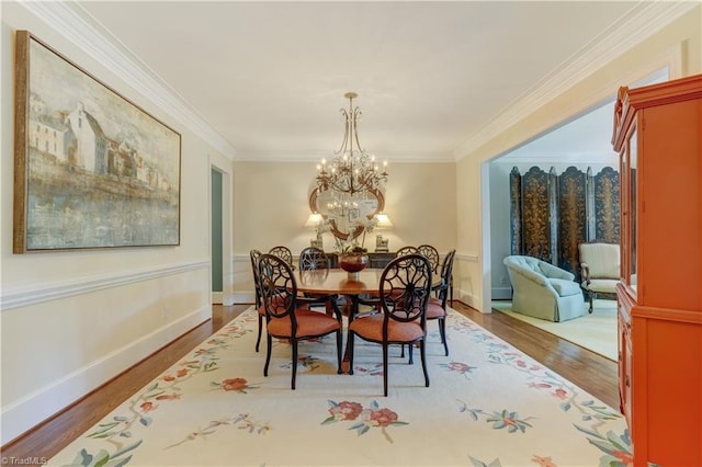 3612 Camden Falls Cir, Greensboro, NC 27410 - dining room with wood finished floors, crown molding, and a chandelier