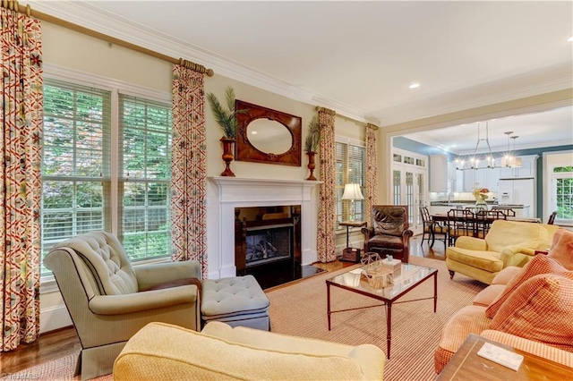 3612 Camden Falls Cir, Greensboro, NC 27410 - living room featuring ornamental molding, wood finished floors, a chandelier, a fireplace with flush hearth, and recessed lighting