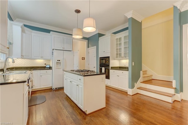 3612 Camden Falls Cir, Greensboro, NC 27410 - kitchen with black appliances, dark countertops, wood finished floors, backsplash, and white cabinetry