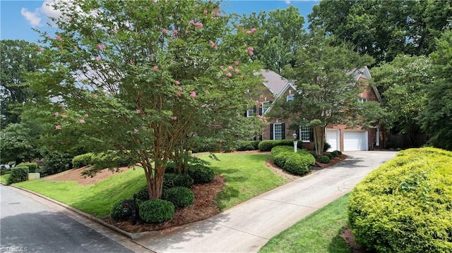 3612 Camden Falls Cir, Greensboro, NC 27410 - view of property hidden behind natural elements with asphalt driveway, an attached garage, and a front yard