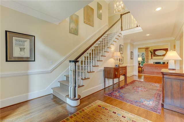 3612 Camden Falls Cir, Greensboro, NC 27410 - staircase featuring crown molding, wood finished floors, a chandelier, and recessed lighting