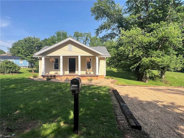 219 Highland Ave, Elkin, NC 28621 - view of front facade with a porch and a front lawn