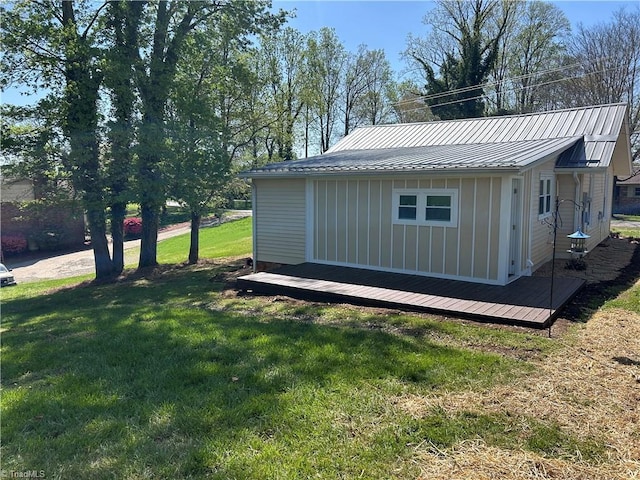 219 Highland Ave, Elkin, NC 28621 - view of side of home with board and batten siding, a yard, and metal roof