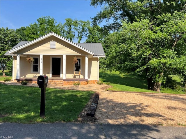 219 Highland Ave, Elkin, NC 28621 - view of front of house with a porch, metal roof, and a front yard