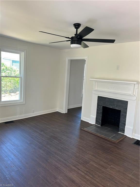 219 Highland Ave, Elkin, NC 28621 - unfurnished living room featuring ceiling fan, dark wood-type flooring, baseboards, and a fireplace