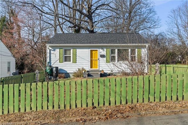 view of front of property with a fenced front yard and entry steps