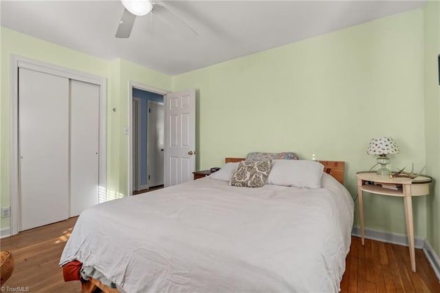 bedroom with a ceiling fan, a closet, baseboards, and wood finished floors