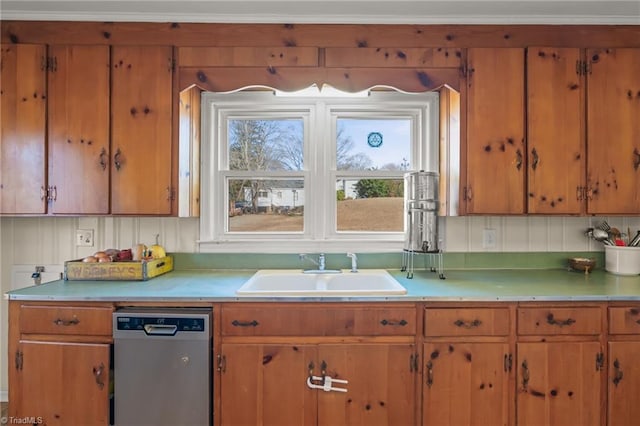 kitchen featuring brown cabinets, light countertops, dishwasher, and a sink