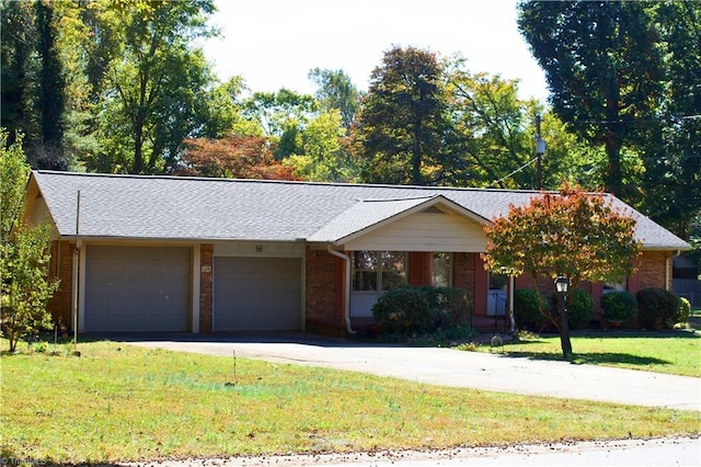 ranch-style house featuring a garage and a front lawn