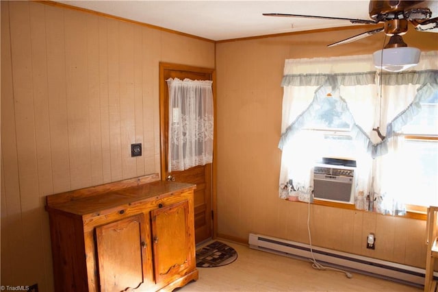 interior space featuring wood walls, a baseboard heating unit, and cooling unit