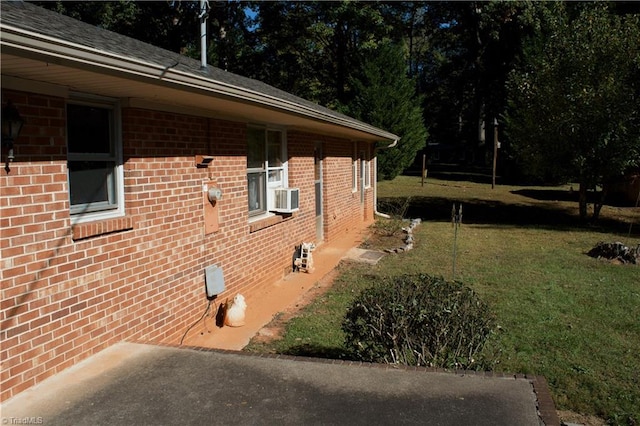 view of home's exterior featuring cooling unit and a lawn