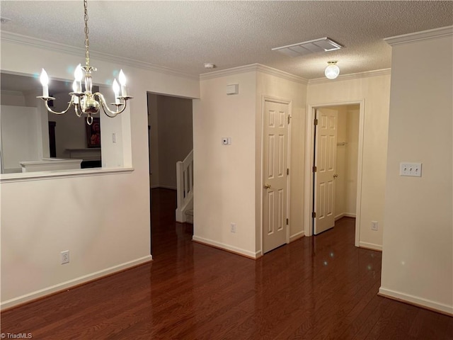 unfurnished room featuring crown molding, a chandelier, a textured ceiling, and hardwood / wood-style flooring