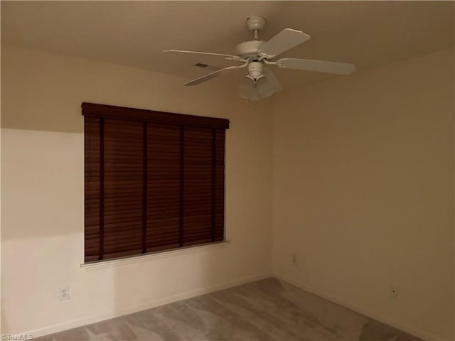 carpeted empty room featuring ceiling fan