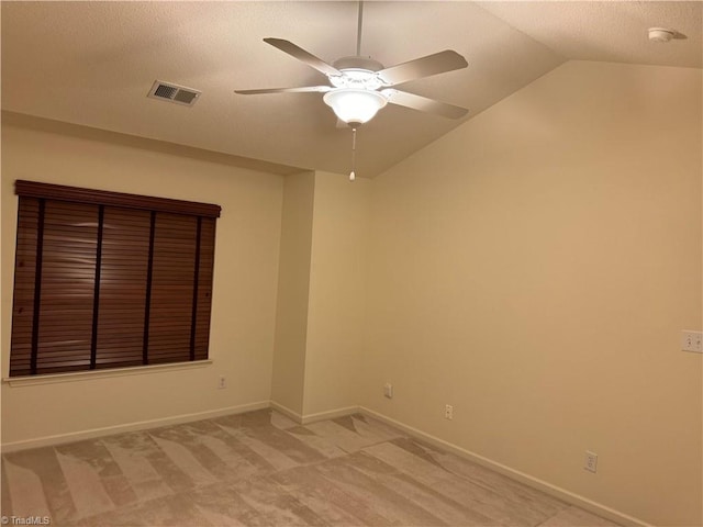 unfurnished room with carpet flooring, lofted ceiling, and ceiling fan