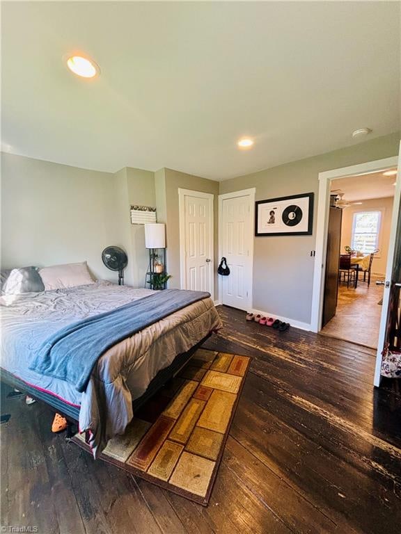 bedroom with dark wood-type flooring