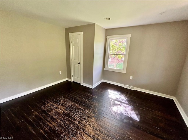 1699 W Pine St, Mount Airy, NC 27030 - empty room featuring dark wood-style flooring and baseboards