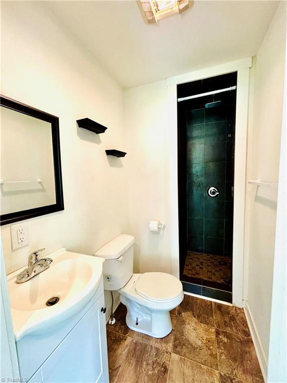 1699 W Pine St, Mount Airy, NC 27030 - full bath featuring vanity, a stall shower, toilet, and baseboards