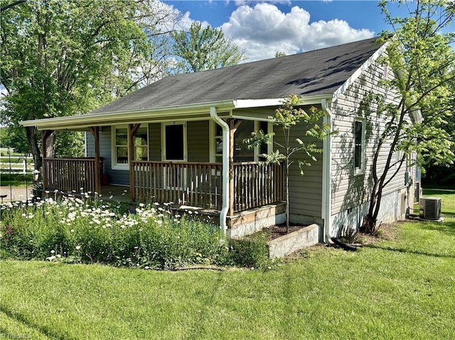 1699 W Pine St, Mount Airy, NC 27030 - view of front facade with a porch, a front lawn, a shingled roof, and central AC unit