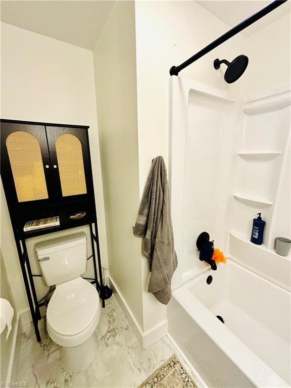 1699 W Pine St, Mount Airy, NC 27030 - full bathroom featuring baseboards, marble finish floors, toilet, and bathtub / shower combination